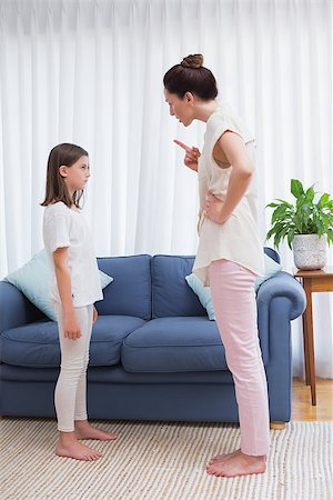 parent scolding kids - Mother scolding her naughty daughter at home in the living room Stock Photo - Budget Royalty-Free & Subscription, Code: 400-08019980