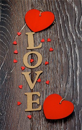 simsearch:400-07954156,k - Cardboard Word Love and Two Red Hearts closeup on Dark Wooden background Foto de stock - Royalty-Free Super Valor e Assinatura, Número: 400-08011127