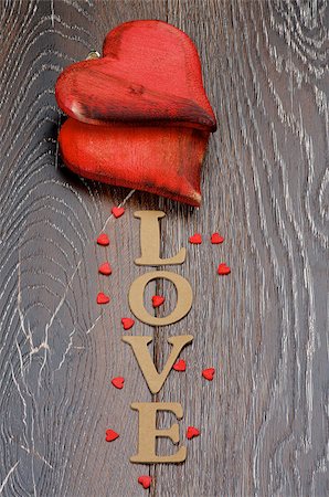 simsearch:400-07954156,k - Two Wooden Red Hearts and Cardboard Word Love isolated on Dark Hardwood background Foto de stock - Royalty-Free Super Valor e Assinatura, Número: 400-08011121