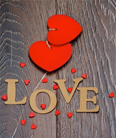 simsearch:400-07954156,k - Two Red Hearts and Cardboard Word Love closeup on Dark Wooden background Foto de stock - Royalty-Free Super Valor e Assinatura, Número: 400-08011123