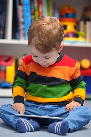 Happy 2 years old boy using a digital tablet computer Stock Photo - Budget Royalty-Free & Subscription, Code: 400-08011969