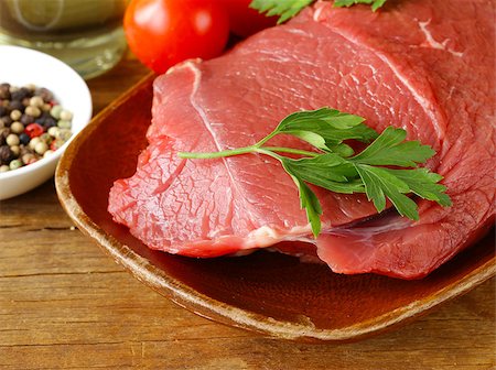 simsearch:652-03803644,k - fresh raw beef meat with pepper and herbs on wooden plate Stock Photo - Budget Royalty-Free & Subscription, Code: 400-08011979