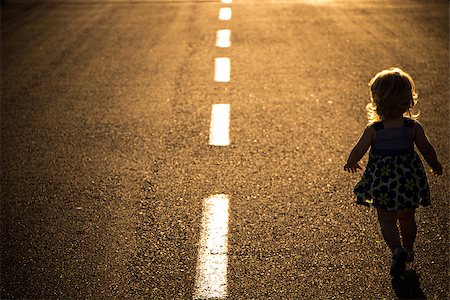 Little girl running away on the road ahead Stock Photo - Budget Royalty-Free & Subscription, Code: 400-08012003