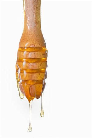 Honey dripping from a wooden honey dipper Photographie de stock - Aubaine LD & Abonnement, Code: 400-08013853