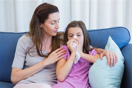simsearch:400-06801081,k - Mother helping daughter blow her nose at home in the living room Photographie de stock - Aubaine LD & Abonnement, Code: 400-08020018