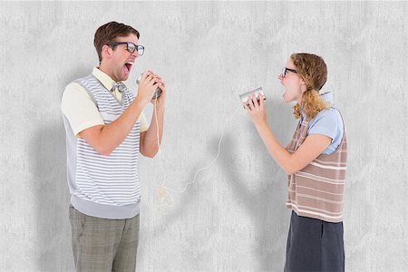 Geeky hipster couple speaking with tin can phone  against white background Stock Photo - Budget Royalty-Free & Subscription, Code: 400-08020414