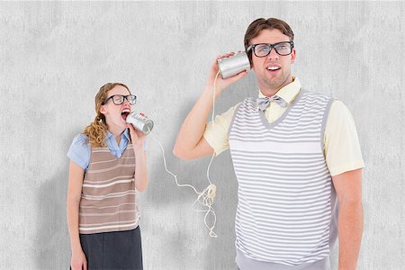 Geeky hipster couple speaking with tin can phone  against white background Stock Photo - Budget Royalty-Free & Subscription, Code: 400-08020415