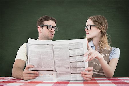 simsearch:400-08380794,k - Geeky hipster couple reading newspaper against green chalkboard Stockbilder - Microstock & Abonnement, Bildnummer: 400-08020424