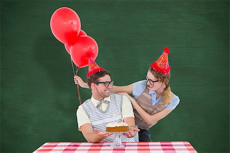 simsearch:400-08380794,k - Geeky hipster couple celebrating his birthday  against green chalkboard Stockbilder - Microstock & Abonnement, Bildnummer: 400-08020421
