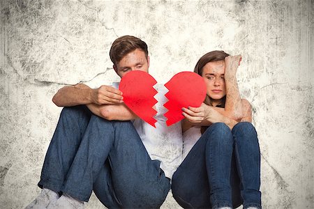 Young couple holding broken heart against grey background Stock Photo - Budget Royalty-Free & Subscription, Code: 400-08020497