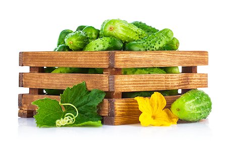 simsearch:400-07667021,k - Fresh cucumbers in wooden box with green leaf and flower. Isolated on white background Stock Photo - Budget Royalty-Free & Subscription, Code: 400-08020815