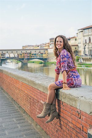 simsearch:400-08020855,k - Happy young woman sitting near ponte vecchio in florence, italy Stockbilder - Microstock & Abonnement, Bildnummer: 400-08020857