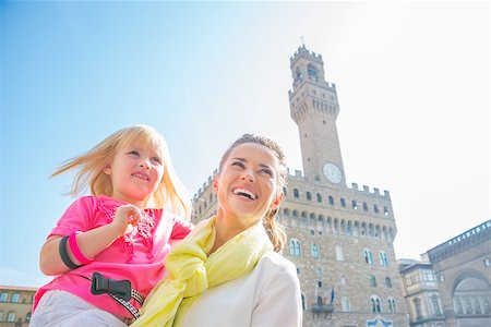 simsearch:400-08134697,k - Happy mother and baby girl looking into distance in front of palazzo vecchio in florence, italy Stock Photo - Budget Royalty-Free & Subscription, Code: 400-08020884
