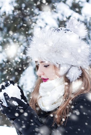 Beautiful young woman enjoying making a snowball. Stock Photo - Budget Royalty-Free & Subscription, Code: 400-08021220