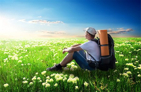 simsearch:400-06892091,k - Tourist sitting on flower field at sunlight Photographie de stock - Aubaine LD & Abonnement, Code: 400-08021766