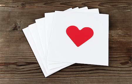 simsearch:400-07326110,k - Stack of white square paper cards with hearts on old wooden background. Envelopes with hearts. Top view. Stock Photo - Budget Royalty-Free & Subscription, Code: 400-08021930