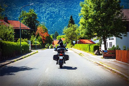 Motorcyclist touring along Austria, Alps, active lifestyle, extreme sport, mountainous village, travel and tourism, speed concept Stock Photo - Budget Royalty-Free & Subscription, Code: 400-08022481