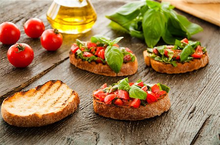 simsearch:824-02888261,k - Italian tomato bruschetta with chopped vegetables, herbs and oil on grilled or toasted crusty ciabatta bread Stock Photo - Budget Royalty-Free & Subscription, Code: 400-08034005