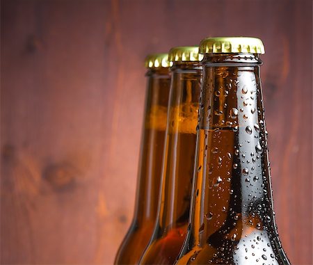 simsearch:400-07165373,k - three bottles of fresh beer with drops on wood background Fotografie stock - Microstock e Abbonamento, Codice: 400-08034199