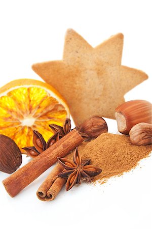 simsearch:400-04145237,k - Natural christmas still life with cinnamon, various nuts, gingerbread cookie and orange on white background. Foto de stock - Royalty-Free Super Valor e Assinatura, Número: 400-08034408