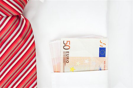 simsearch:400-06102745,k - Fifty euro banknotes in pocket of a businessman with red tie close up. Pay day. Photographie de stock - Aubaine LD & Abonnement, Code: 400-08034444