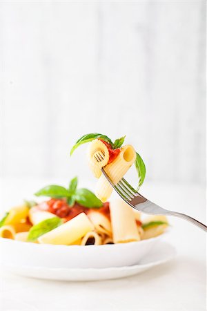 simsearch:400-04031652,k - Pasta with Tomato Sauce and Basil on a Fork. Italian food. Mediterranean cuisine Stock Photo - Budget Royalty-Free & Subscription, Code: 400-08034547