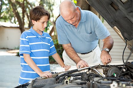 Father teaching his son basic auto maintenance. Stock Photo - Budget Royalty-Free & Subscription, Code: 400-08034917
