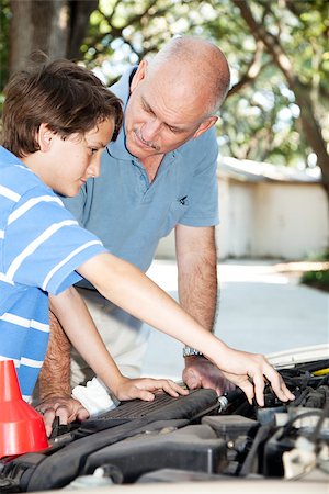 Father teaching his son how to do auto repairs, oil change, etc. Stock Photo - Budget Royalty-Free & Subscription, Code: 400-08034926