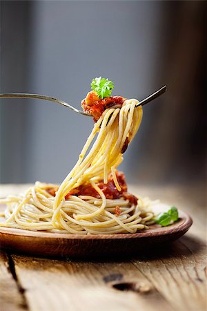 Italian food. Pasta spaghtti with tomato sauce, olives and garnish Stock Photo - Budget Royalty-Free & Subscription, Code: 400-08035483