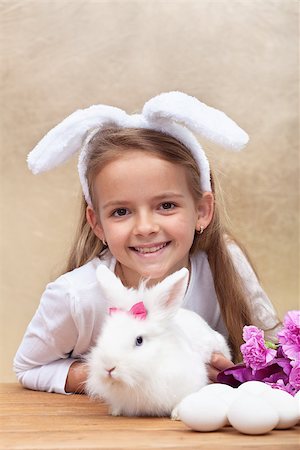 simsearch:400-07254895,k - Happy little girl with bunny ears and her cute white rabbit preparing for easter Stock Photo - Budget Royalty-Free & Subscription, Code: 400-08036286