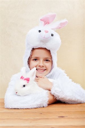 simsearch:400-07254895,k - Cute little girl in bunny costume holding her white rabbit - laughing with joy Stock Photo - Budget Royalty-Free & Subscription, Code: 400-08036294