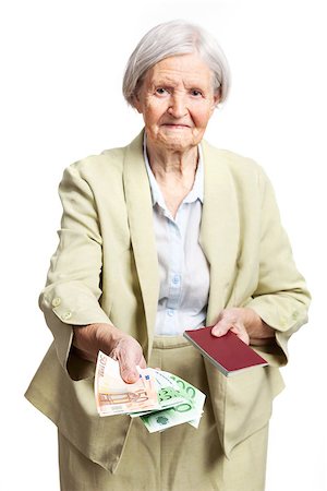 passport background - Senior woman giving money and holding passport, hand with money in focus. Isolated over white Stock Photo - Budget Royalty-Free & Subscription, Code: 400-08036322