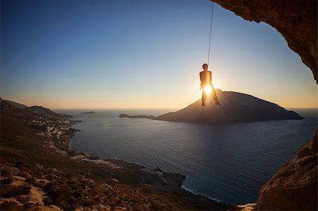 simsearch:400-07292725,k - Rock climber hanging on rope while lead climbing at sunset, with Telendos island in background. Kalymnos island, Greece. Photographie de stock - Aubaine LD & Abonnement, Code: 400-08036335