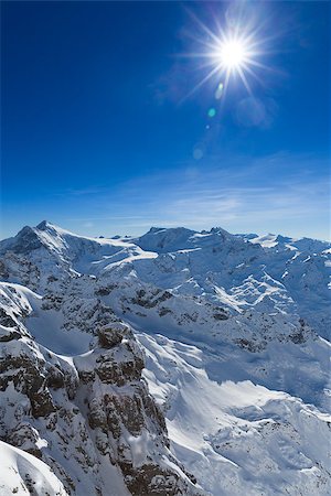 Beautiful view from the Swiss mountain Titlis towards the South. On the horizon from left to right you can see the moutains Sustenhorn, Dammastock, Tierberge and Diechterhorn. Fotografie stock - Microstock e Abbonamento, Codice: 400-08036879