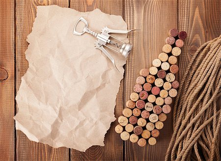 simsearch:400-07933837,k - Wine bottle shaped corks, corkscrew and piece of paper for copy space over rustic wooden table background. Top view Stockbilder - Microstock & Abonnement, Bildnummer: 400-08037225