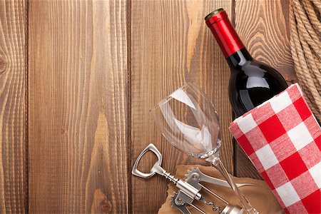 simsearch:400-07937813,k - Red wine bottle, wine glass and corkscrew on wooden table background with copy space Photographie de stock - Aubaine LD & Abonnement, Code: 400-08037229