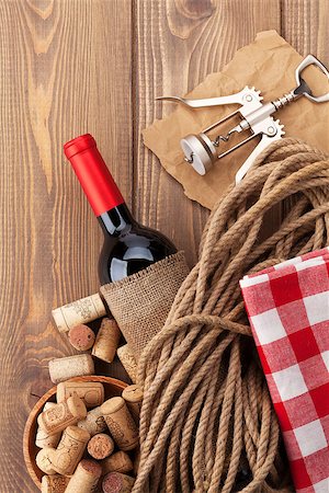simsearch:400-07933837,k - Red wine bottle, corks and corkscrew on wooden table background with copy space Stockbilder - Microstock & Abonnement, Bildnummer: 400-08037234