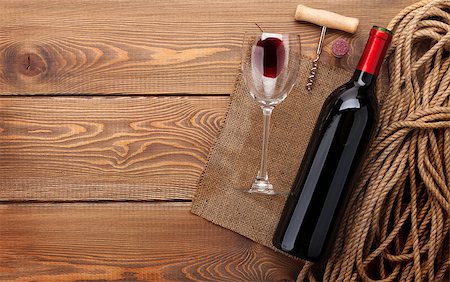 simsearch:400-07933837,k - Red wine bottle, wine glass and corkscrew on wooden table background with copy space Stockbilder - Microstock & Abonnement, Bildnummer: 400-08037237