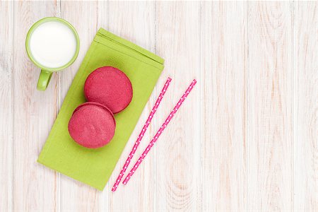 Colorful macarons and cup of milk on white wooden table with copy space Stock Photo - Budget Royalty-Free & Subscription, Code: 400-08037247
