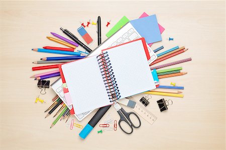 Blank notepad over school and office supplies on office table. Top view with copy space Stock Photo - Budget Royalty-Free & Subscription, Code: 400-08037309