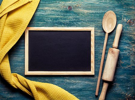 Yellow towel, wooden spoon, rolling pin and small blackboard on wooden background Stock Photo - Budget Royalty-Free & Subscription, Code: 400-08037755