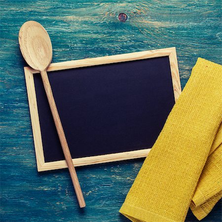 Black chalk board with yellow towel and wooden spoon. Kitchen tools Stock Photo - Budget Royalty-Free & Subscription, Code: 400-08037756