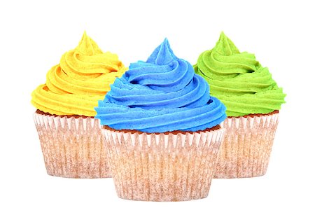 simsearch:614-03903060,k - Three cupcakes with colorful yellow, blue and green frosting isolated on a white background Photographie de stock - Aubaine LD & Abonnement, Code: 400-08039266