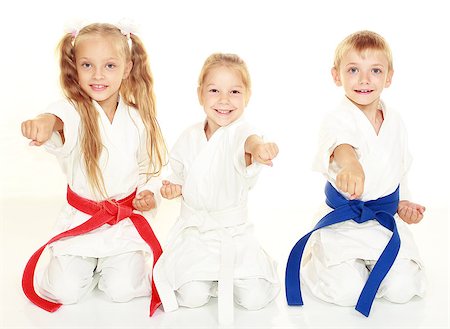 Cheerful young children to sit in a ceremonial kimono karate pose and hit a punch Photographie de stock - Aubaine LD & Abonnement, Code: 400-08032465