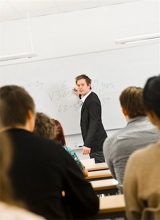 Schoolteacher in front of pupils in the classroom Stock Photo - Budget Royalty-Free & Subscription, Code: 400-08032680