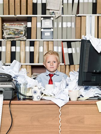 Young boy as a business man in a messy office Stock Photo - Budget Royalty-Free & Subscription, Code: 400-08032806