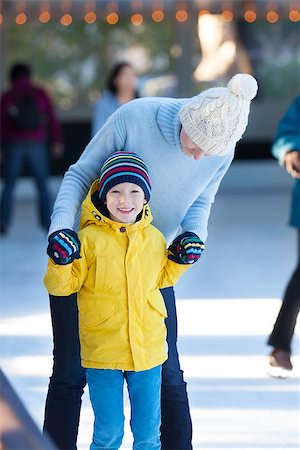 simsearch:400-08318057,k - happy family of mother and her son enjoying ice skating together at winter at outdoor skating rink Stock Photo - Budget Royalty-Free & Subscription, Code: 400-08033348