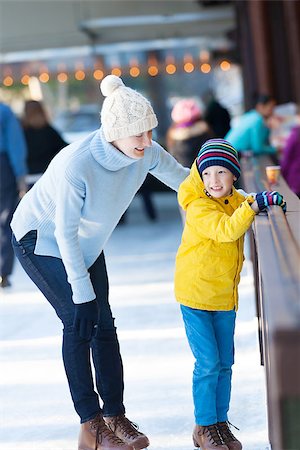 simsearch:400-08315867,k - happy family of mother and her son enjoying ice skating together at winter at outdoor skating rink Photographie de stock - Aubaine LD & Abonnement, Code: 400-08033354