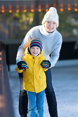 simsearch:400-08034847,k - happy family of mother and her son enjoying ice skating together at winter at outdoor skating rink Photographie de stock - Aubaine LD & Abonnement, Code: 400-08033352