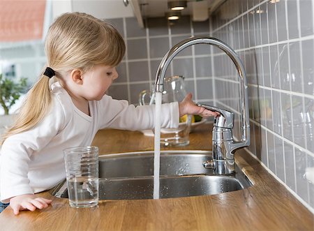 Small Girl in the kitchen drinking water Stock Photo - Budget Royalty-Free & Subscription, Code: 400-08033583